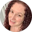 Homeowner profile: Smiling woman with curly auburn hair.
